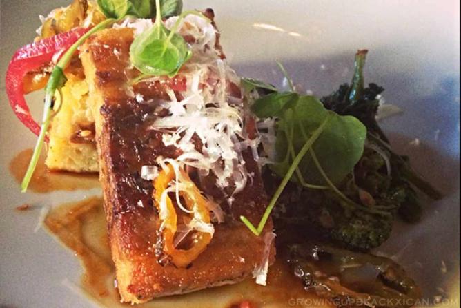 A garnished plate with fresh ingredients at Sbraga.