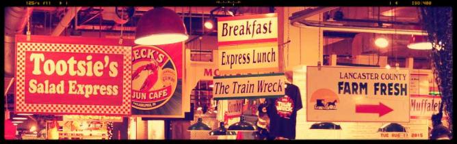 A view of the numerous signs as you navigate your way through Reading Terminal Market.