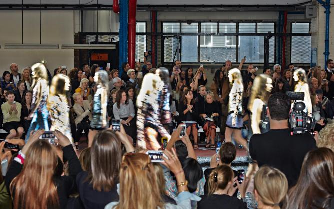 Shulman watching designer Mary Katrantzou’s Spring/Summer 2015 show. Photograph by Kate Martin © Transglobe Publishing