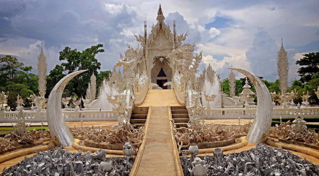 Beautiful ornate white temple located in Chiang Rai northern Thailand. Wat Rong Khun (White Temple), is a contemporary unconventional Buddhist temple.Buddhist and Hindu motifs. © YURY TARANIK / ShutterStock