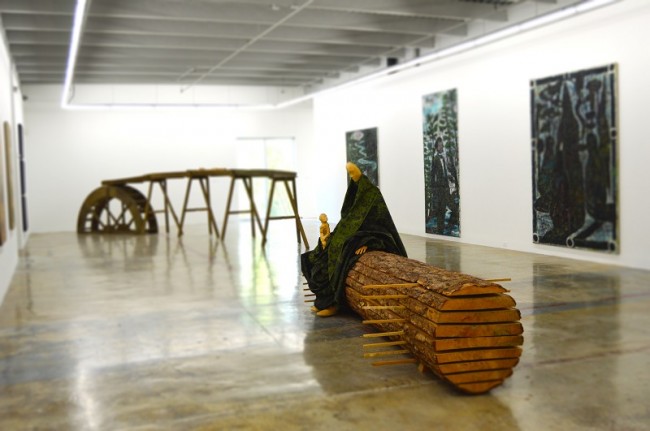 Waldfrau, getarnt, 2002, limewood, larch tree and camouflage fabric, 62 x 169 x 45 in. by Paloma Varga Weisz (Germany), acquired by the Rubell Family Collection in 2003 | © Lisa Morales