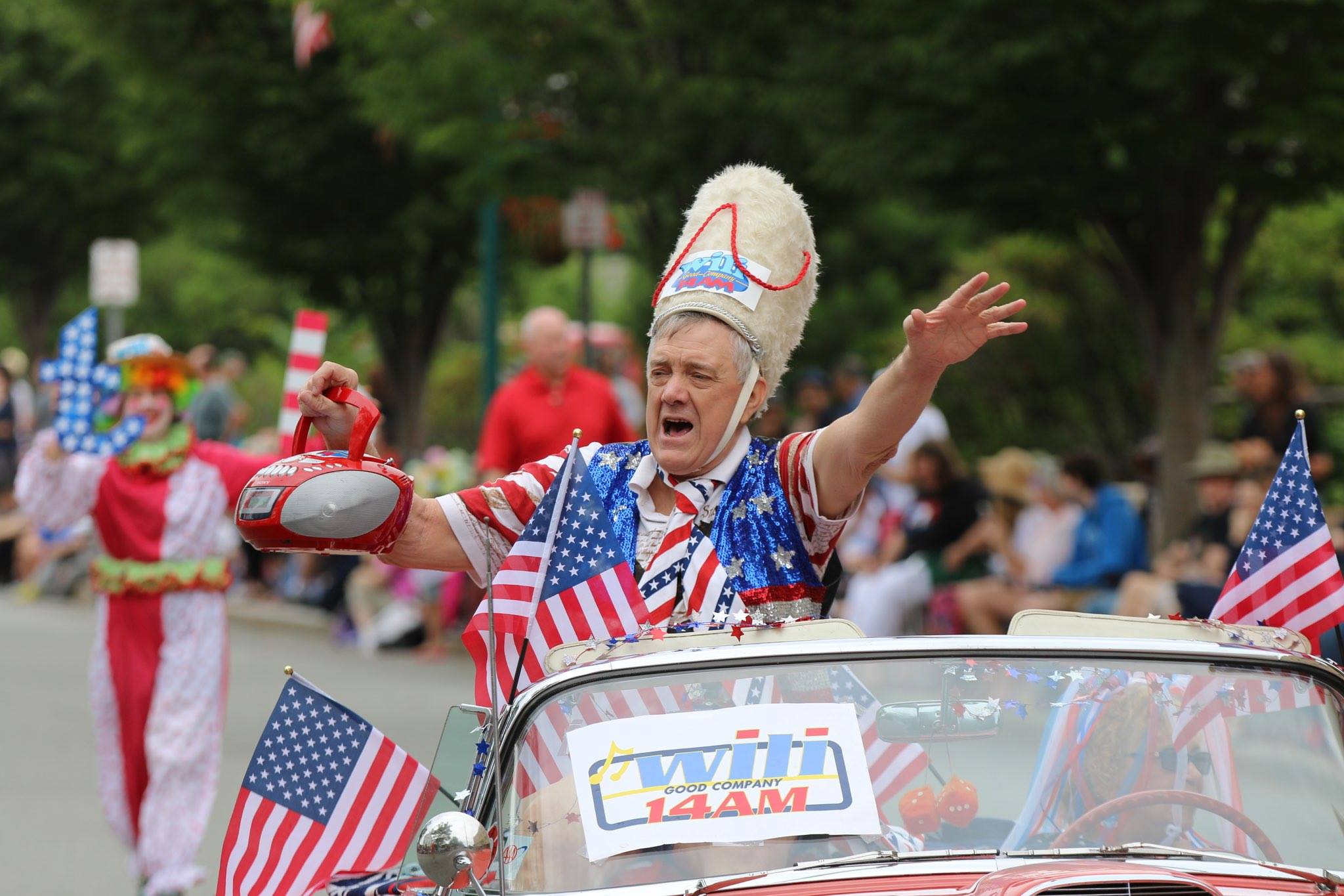 Boom Box Parade Grand Marshal Wayne Norman blasting his boom box while leading the 2015 parade atop a classic 1956 Thunderbird | © Peter Polomski