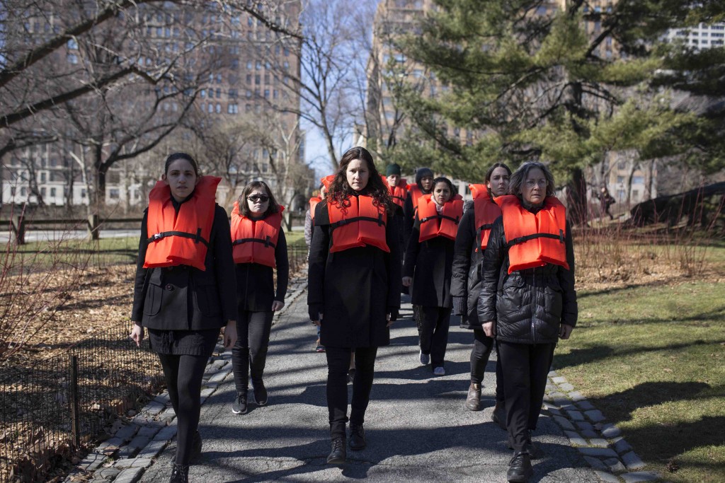 In the Greek Georgia Lale's #OrangeVest performance, people dressed in black and a orange life vest keep popping up along the parcours | © George Xourafas/courtesy of Nuit Blanche