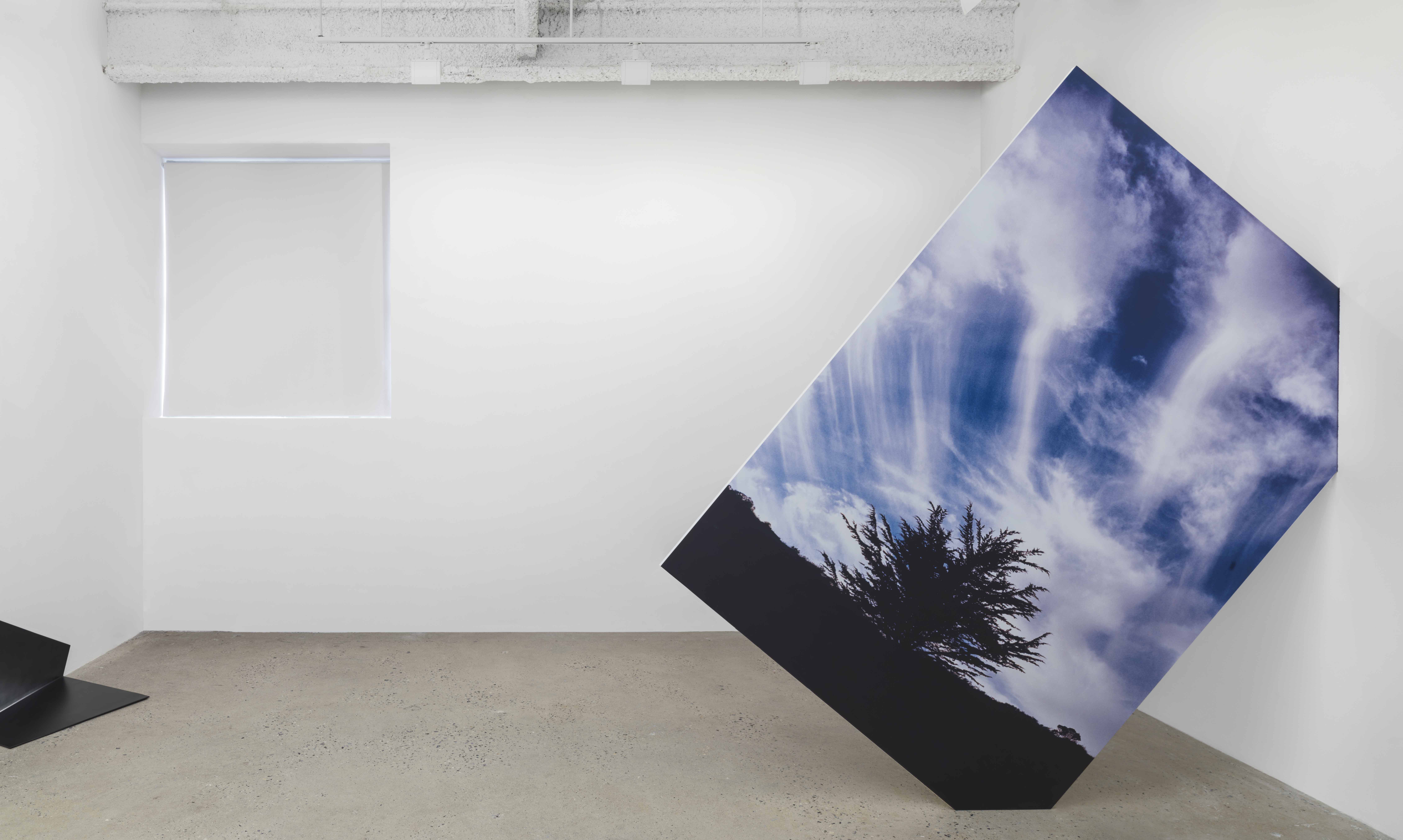 Installation view, Solo exhibition at Higher Pictures, 2014 Skyfall Wallbreak California, 2014 UV print on dibond, wood, hole in wall 96 x 96 x 7/8 inches | Courtesy of Letha Wilson