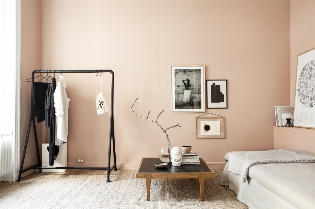 This Stockholm apartment by stylist Emma Wallmen mixes a warm pink with natural materials for a cosy feel