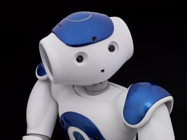 A Nao V5 Evolution humanoid sits up
