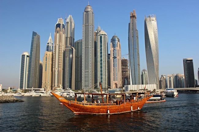 'The Tallest Block' in Dubai Marina. Located in the center is the Princess Tower and located on the far right is the Cayan Tower | © Steven Straiton / Flickr https://www.flickr.com/photos/st33vo/29839279175/in/photolist-h11sfG-pTZvpX-pUN34k-pTS2d1-qcaVpS-qc47YB-qagDiH-pdsniN-pT2WZV-q8aAFY-pftqhZ-pUEkcU-q9X9gW-pdsR5Q-pSTtFy-qagF4g-qarBmk-qasrwt-FxQUgH-MsN77B-pT4pvP-q99s7E-NLydLw-oYidU3