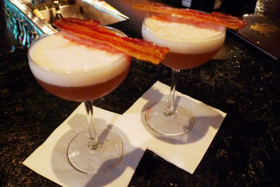 Two cocktails with bacon on them