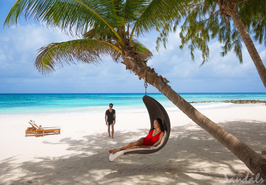Rest beneath the shade of tropical palm and enjoy the gentle ocean breezes | Courtesy of Sandals Barbados