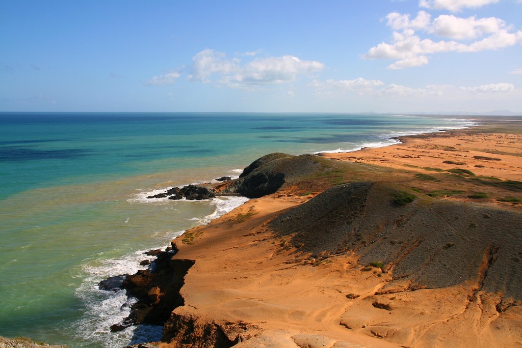 Where the bright orange of the La Guajira desert meets the Caribbean Sea © Tanenhaus / Flickr