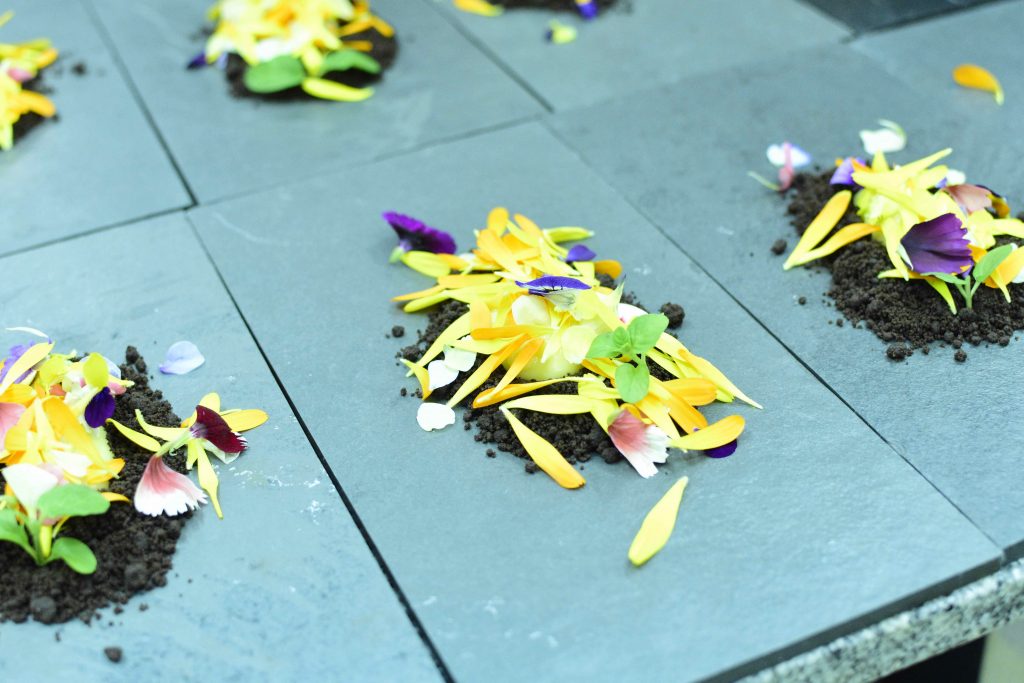 Kalma dessert pate featuring cocoa "earth" and local mountain flowers | Courtesy of Kalma