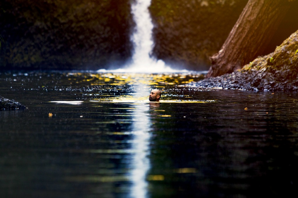 Swimming by waterfall