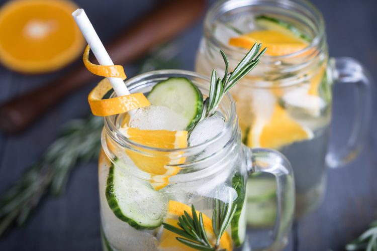Homemade orange lemonade with cucumber and rosemary