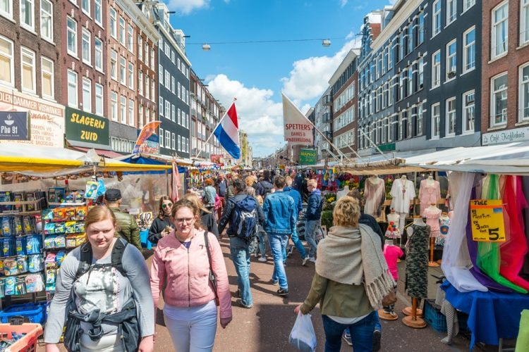 Tourists walk in Albert Cuyp Market, Amsterdam