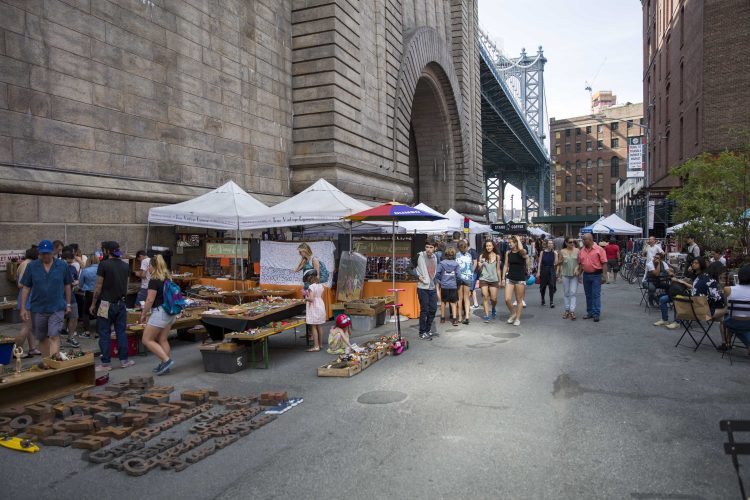 People at Brooklyn Flea market in DUMBO, New York. Brooklyn Flea runs several of the largest flea markets on the East Coast of the United States.