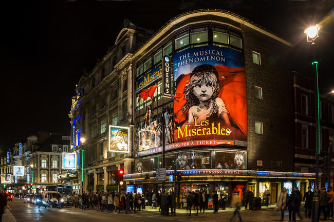London's West End at night with Les Miserables at Queens Theatre in Shaftesbury Avenue.