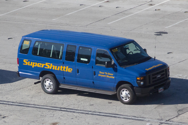 A Super Shuttle van parked at Miami International Airport