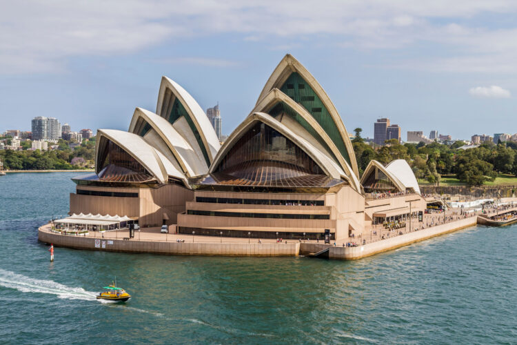 Water taxi passing Sydney Opera House.