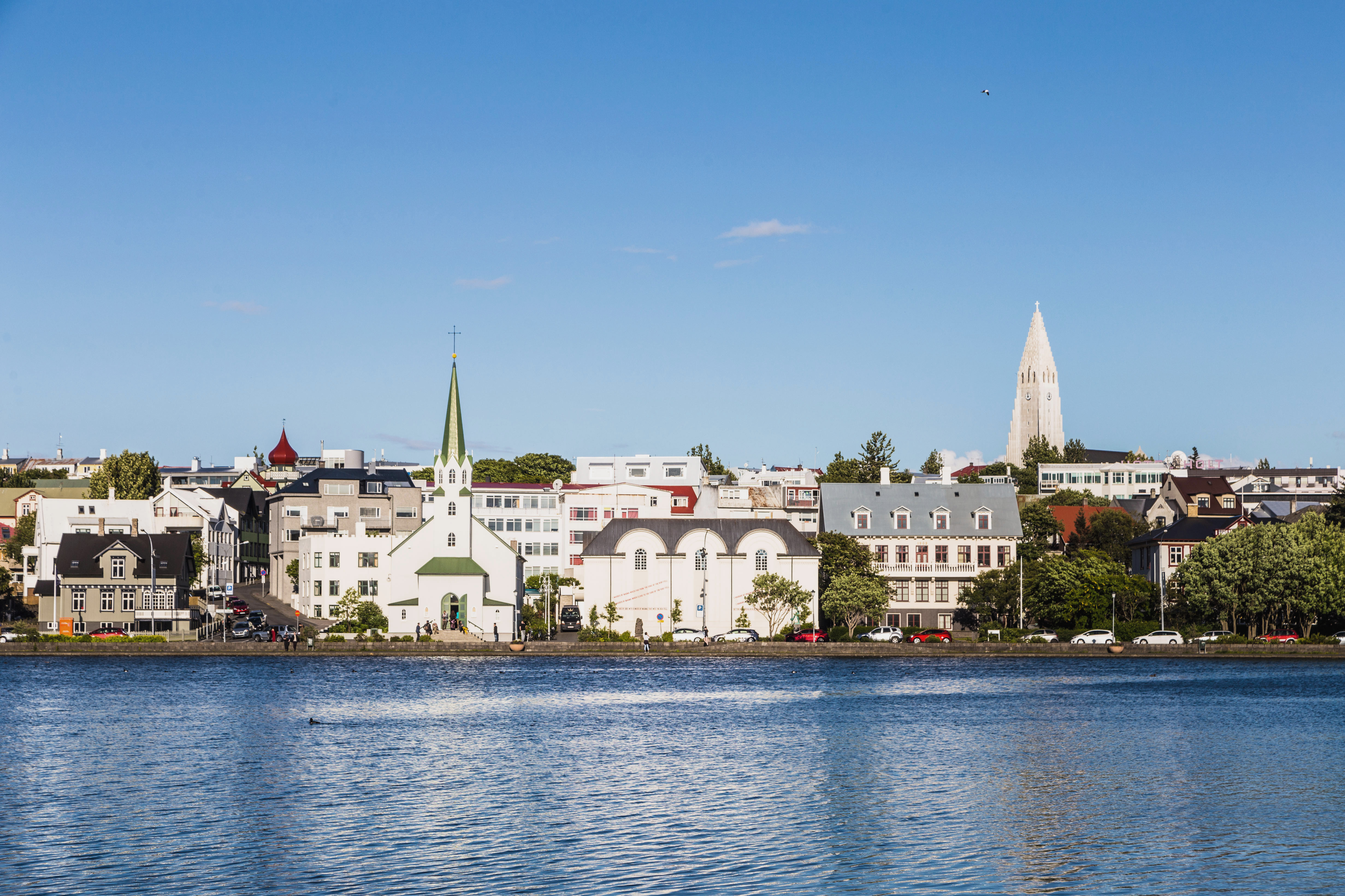 Reykjavik cityscape, with the bell tower of the Hallgrimskirkja church, viewed from across the Tjornin lake in the heart of Iceland capital city on a