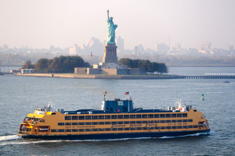 A Staten Island ferry passing the Statue of Liberty in New York