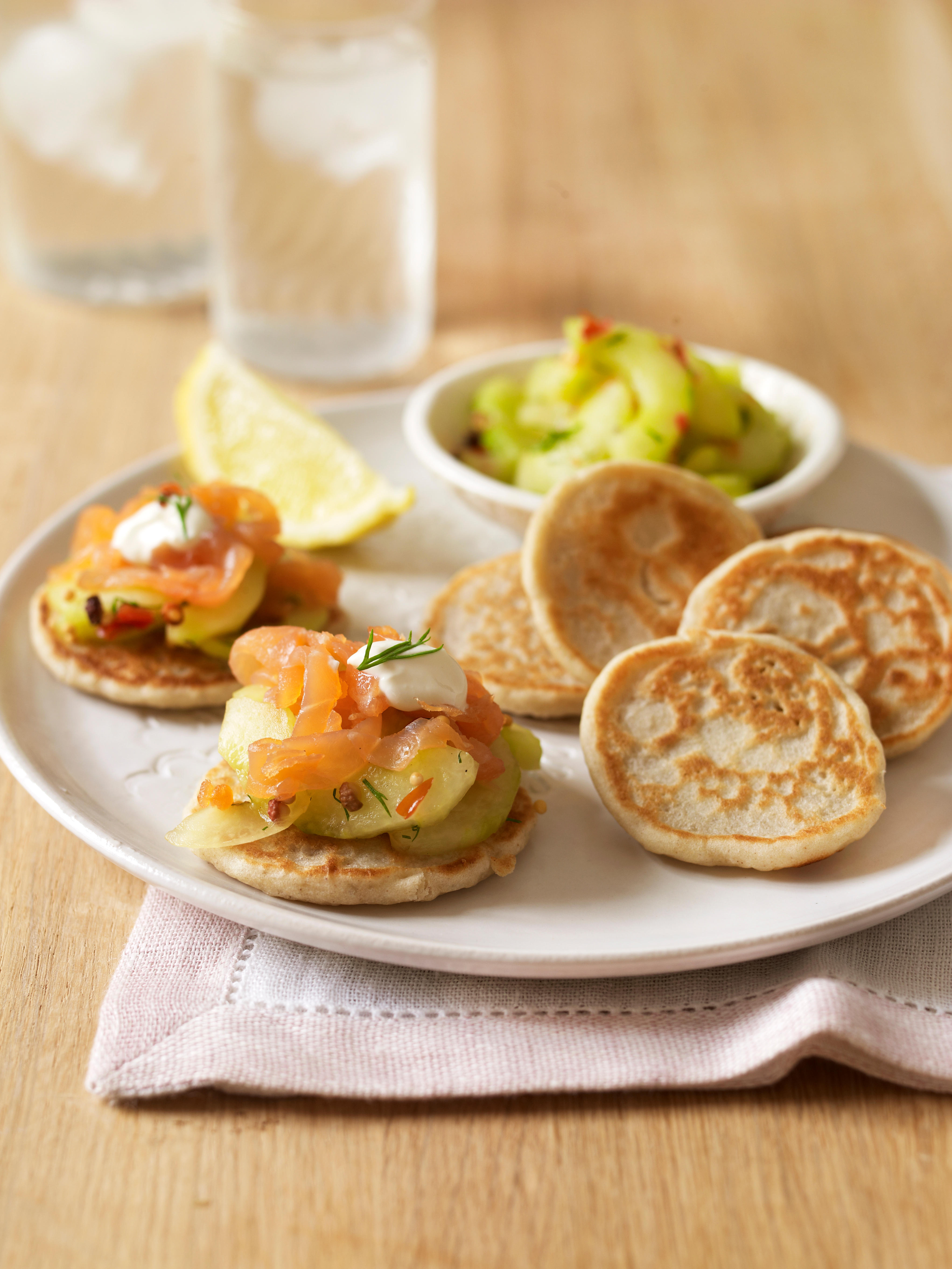Gluten-free blinis (Russian pancakes) with smoked trout, cucumber and sour cream
