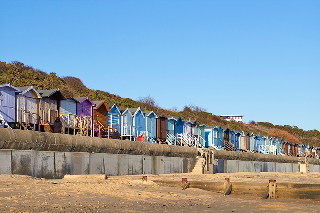 Multi-coloured beach huts add a pop of colour to Frinton-on-Sea's beachfront