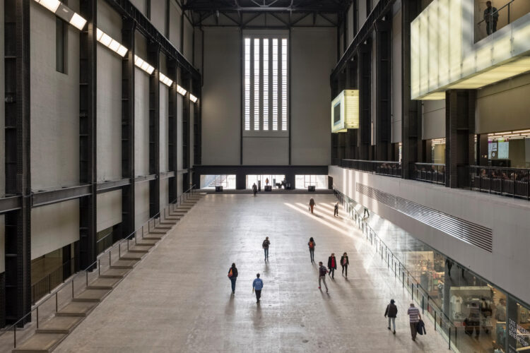 Visitors on the entrance ramp to the the vast Turbine Hall at Tate Modern, Bankside, London, UK