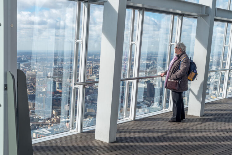 A woman looks out at The View From The Shard, London, UK